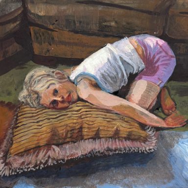 A person with short hair lies on a pillow, curled up on a textured floor.