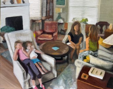 Two adults and two young girls sit in a cozy living room, engaged in conversation.